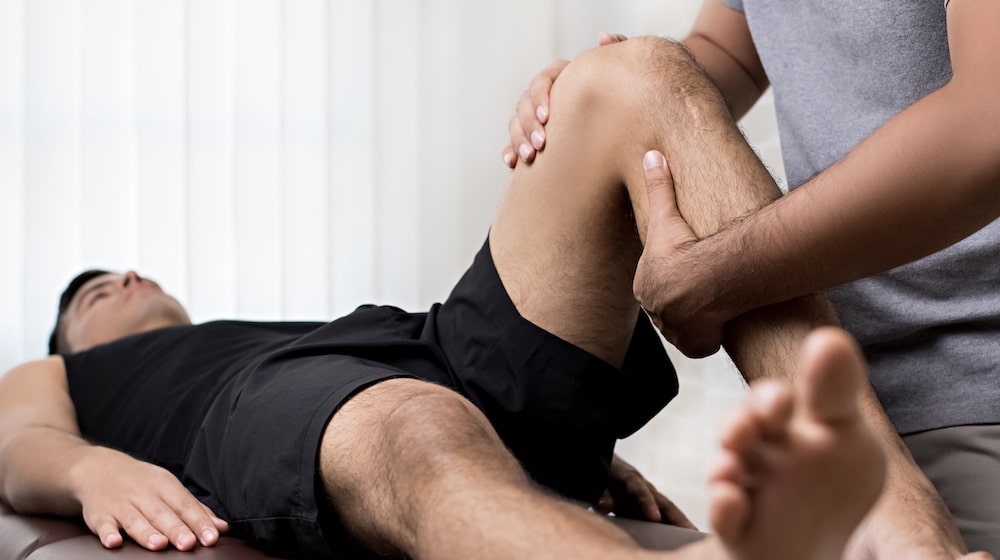Practical application of Level 3 Diploma in Sports Massage working on leg injury in male client